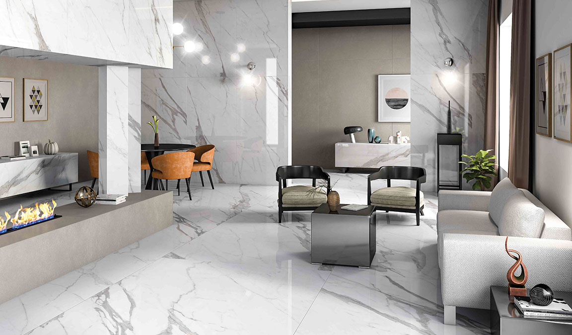Comprar gres porcelánico mármol es una de las tendencias más populares en el diseño de interiores. La clave de su éxito no solo se debe a la excepcional calidad del gres porcelánico. El porcelánico imitación mármol da un toque de lujo en dónde quiera que esté. La naturalidad y la elegancia del pavimento porcelánico imitación mármol se juntan para crear espacios modernos y lujosos. ¿Estás interesado en comprar pavimento online? ¡Sigue leyendo! El pavimento porcelánico imitación mármol La elegancia del pavimento porcelánico imitación mármol puede deberse a la popularidad misma del mármol. Este material ha sido usado en siglos para todo tipo de construcciones y ahora, con la tecnología, llega algo mucho mejor: el porcelánico imitación mármol. El pavimento porcelánico es la baldosa con una de las mejores propiedades mecánicas. Así que si has decidido comprar pavimento online, está es la mejor opción. No solo es un material resistente, limpio e impermeable. Sus características permiten aplicar este pavimento en todo tipo de superficies y espacios. Sus grandes ventajas en el uso y su gran durabilidad, pueden observarse en el precio. ¡Y sabrás más de sus ventajas más adelante! ¿Por qué es mejor el gres porcelánico imitación mármol? Al querer comprar gres porcelánico mármol es normal preguntarse ¿Por qué este material y no el mármol? El mármol, si bien es codiciado por su belleza, provoca grandes inconvenientes, cómo por ejemplo: ● Siendo un material natural, es susceptible a marcharse por productos ácidos y abrasivos cómo la lejía. ● El mármol requiere muchísimos cuidados. Cómo resultado, no sólo exige del dueño un mantenimiento constante, también invertir en productos dirigidos al mármol que suelen ser costosos. ● Es difícil eliminar sus manchas por el alto índice de porosidad. ● También es poco resistente a las rayaduras, por lo cual puede arañarse con mucha facilidad. Y su reparación es imposible. ● En comparación con el gres porcelánico imitación mármol, el material en sí (mármol) tiene un precio excesivamente alto. Ventajas de escoger el pavimento porcelánico imitación mármol La imitación mármol se ha posicionado como el primero en la lista de diseños en interiores y reformas. Veamos sus ventajas: 1. Es “para toda la vida” Independientemente de las condiciones ambientales, altas temperaturas o el tratamiento (cómo la limpieza) la apariencia de la superficie no cambia. 2. Excelente relación calidad-precio El pavimento porcelánico imitación mármol no necesita un gran proceso de mantenimiento. Y al ser tan duraderos es posible ahorrar dinero en reformas. 3. Un material para todo tipo de lugares Puedes colocar este material en todo tipo de infraestructuras. Desde recepción de edificios, hasta centros comerciales, terrazas, piscinas o jardines. 4. Es 100% higiénico e impermeable Una de sus mayores ventajas es su acabado 100% libre de porosidades. Gracias a esto evita la absorción de cualquier tipo de líquido o humedad.